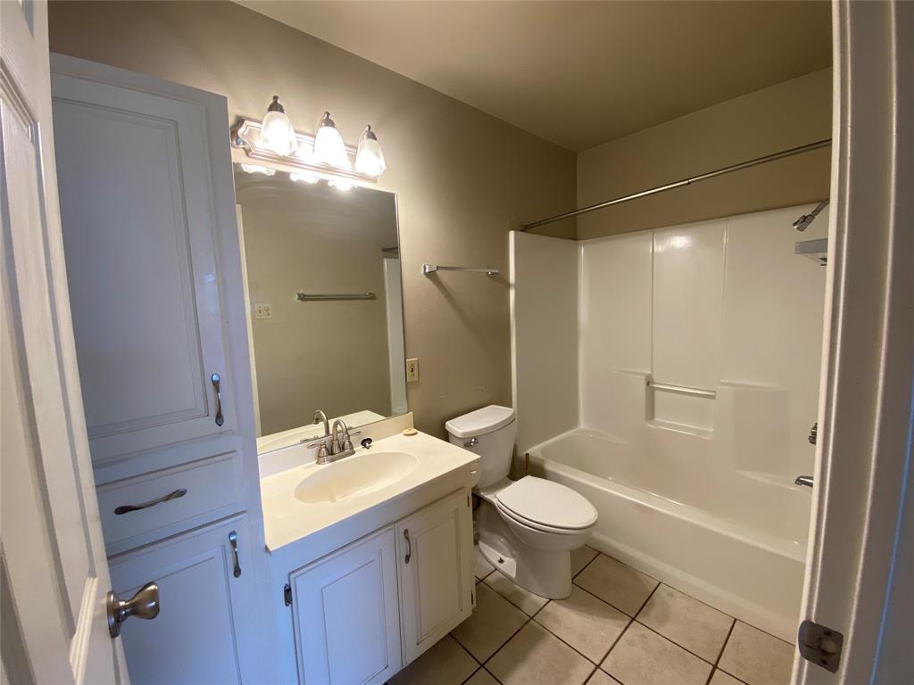 3241 Lexington Drive Tyler, TX 75701 - Photo 4 of 17 a bathroom with a sink a toilet and shower