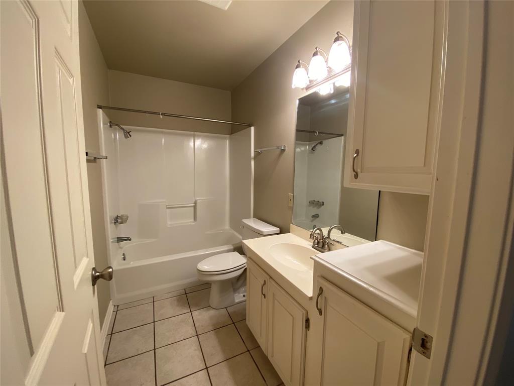 3241 Lexington Drive Tyler, TX 75701 - Photo 7 of 17 a bathroom with a sink a toilet and shower
