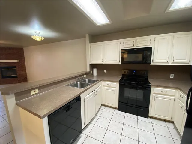 a kitchen with a sink stove and microwave
