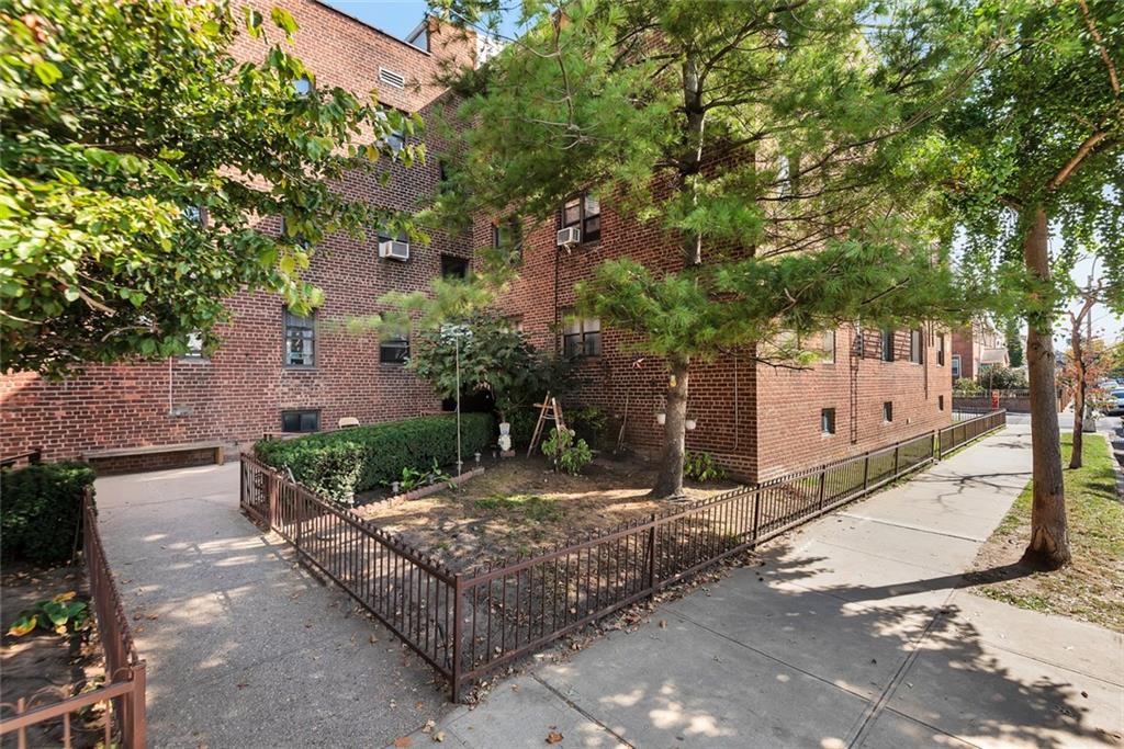 1265 Shore Parkway, Unit 2C Brooklyn, NY 11214 - Photo 10 of 11 a tree in front of a white house
