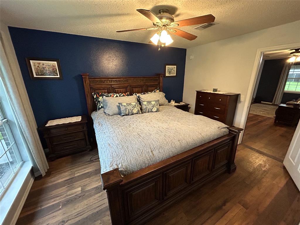 1974 County Road Powderly, TX 75473 - Photo 13 of 33 a bedroom with a bed and a flat screen tv