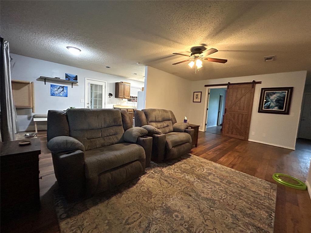 1974 County Road Powderly, TX 75473 - Photo 2 of 33 a living room with furniture and a flat screen tv
