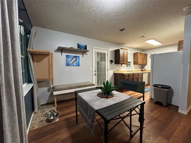 a room with a table chairs and entryway