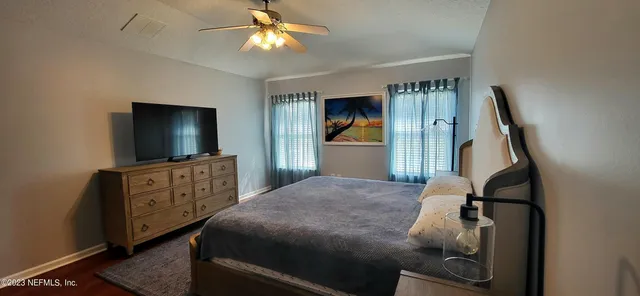 a bedroom with furniture and a flat screen tv