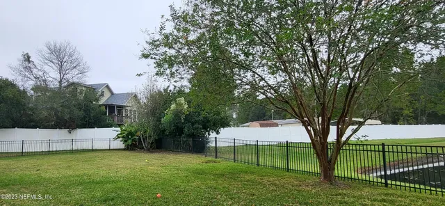 a view of a backyard with large trees