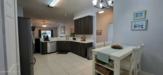 a kitchen with a sink refrigerator and microwave