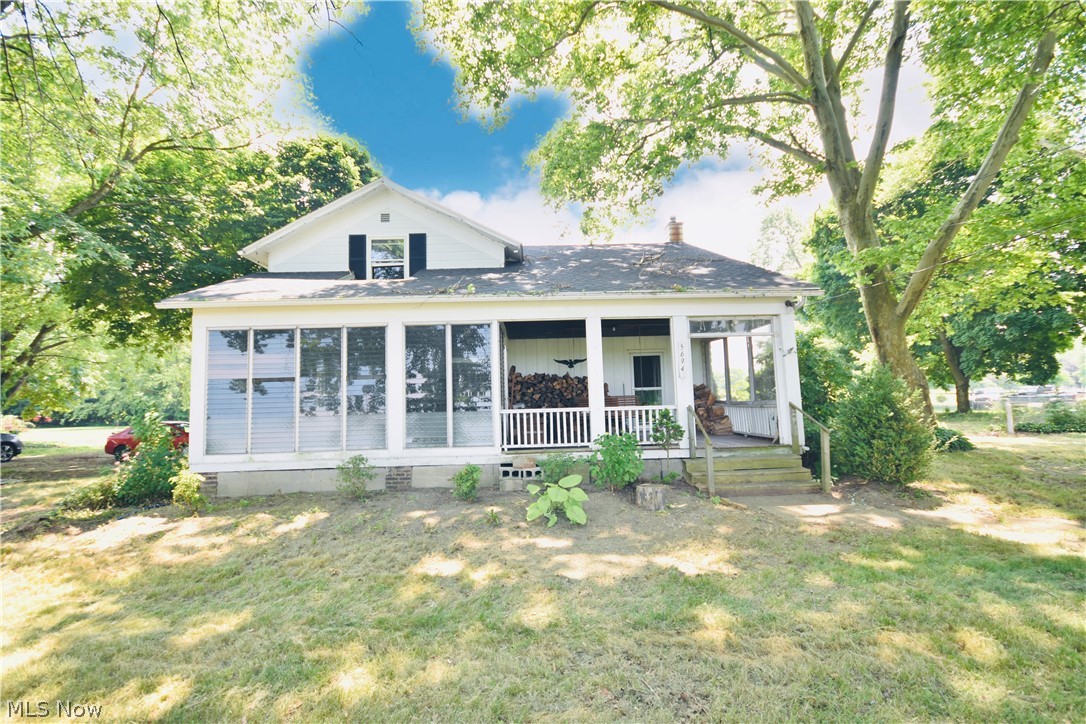 5694 Middle Ridge Road Madison, OH 44057 - Photo 1 of 27 View of front of property with a front yard and covered porch