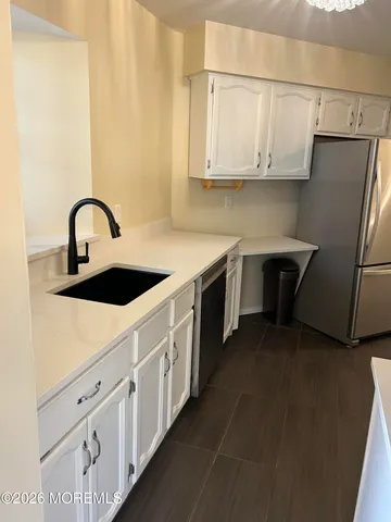 a kitchen with stainless steel appliances granite countertop a sink a stove and refrigerator