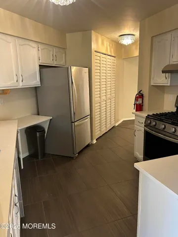 a kitchen with stainless steel appliances a refrigerator and a stove top oven