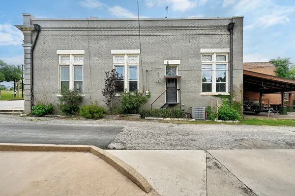 a view of backyard with a patio and a garden