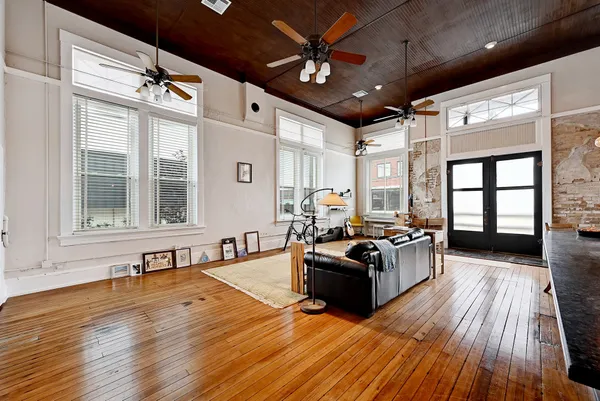 a living room with furniture fireplace and wooden floor