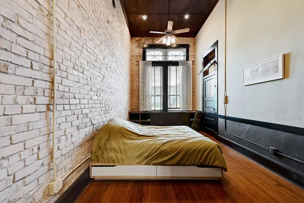 a bedroom with a bed and a chandelier