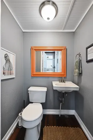 a bathroom with a sink a toilet and mirror