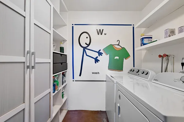 a view of a workspace with furniture and a flat screen tv