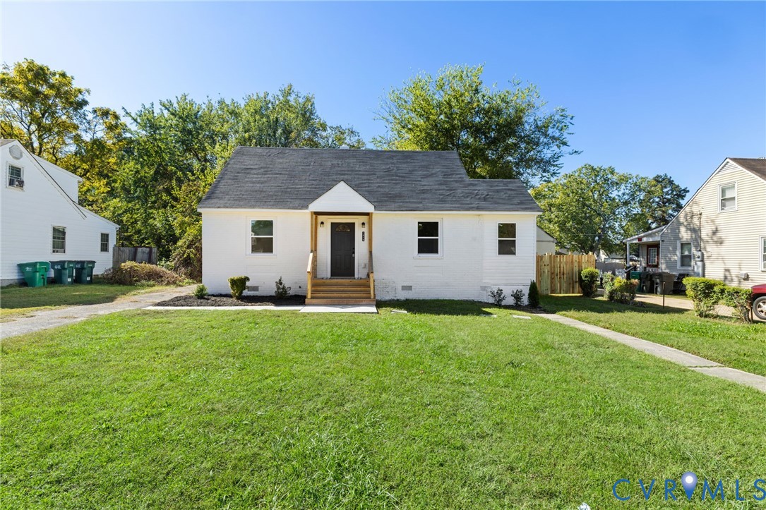 1815 Doron Lane Richmond, VA 23223 - Photo 1 of 26 a front view of a house with a garden and yard