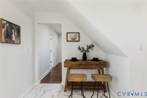 a dining room with furniture and wooden floor