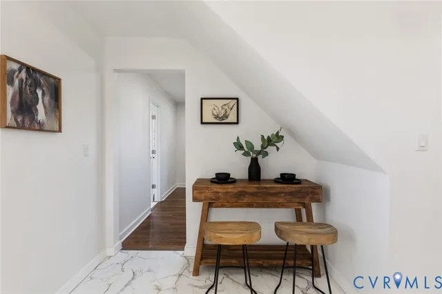 a dining room with furniture and wooden floor