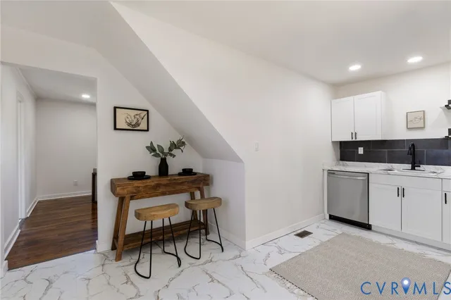 a living room with furniture a dining table and a stove top oven