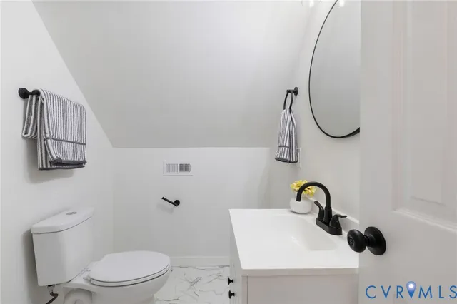 a bathroom with a sink a toilet and vanity