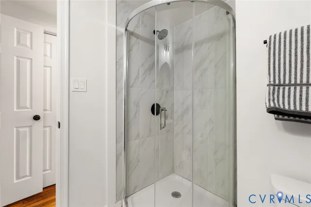 a bathroom with a glass shower door