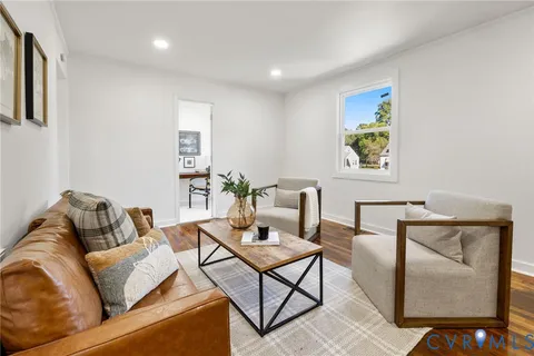 a living room with furniture and painting on the wall