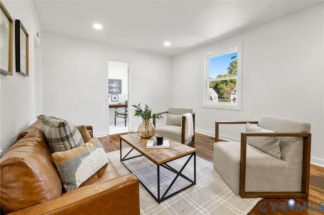 a living room with furniture and painting on the wall