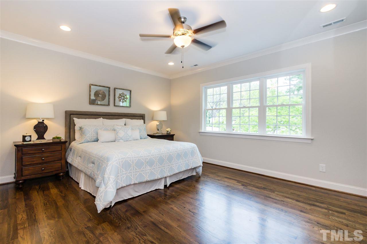 3201 Plantation Road Raleigh, NC 27609 - Photo 12 of 25 a spacious bedroom with a bed and a ceiling fan