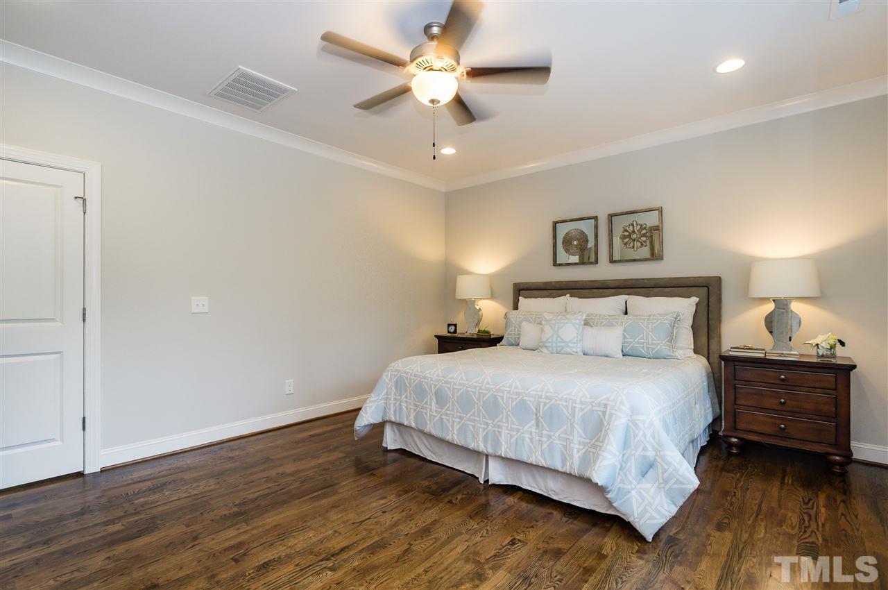 3201 Plantation Road Raleigh, NC 27609 - Photo 13 of 25 a bedroom with a bed and a ceiling fan