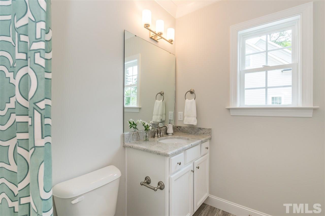 3201 Plantation Road Raleigh, NC 27609 - Photo 18 of 25 a bathroom with a granite countertop sink toilet and mirror