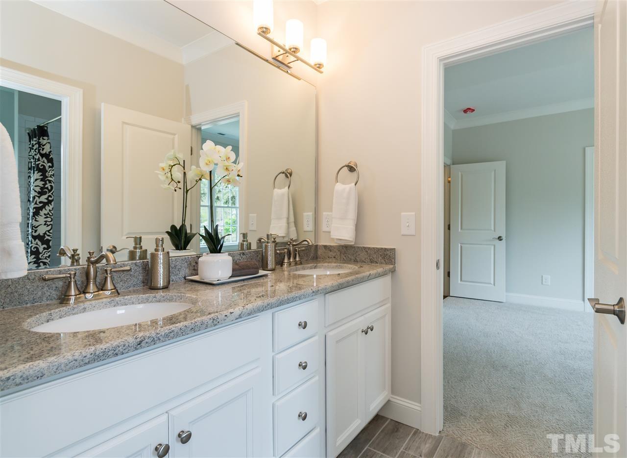 3201 Plantation Road Raleigh, NC 27609 - Photo 19 of 25 a bathroom with double sink and a mirror