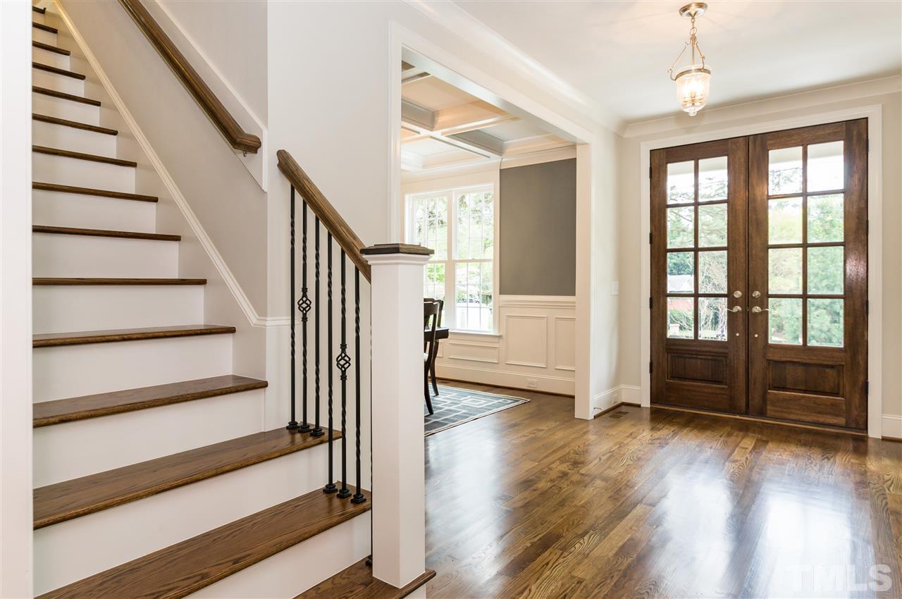 3201 Plantation Road Raleigh, NC 27609 - Photo 3 of 25 a view of a livingroom with wooden floor and stairs