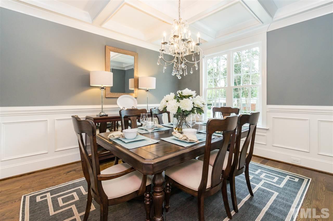 3201 Plantation Road Raleigh, NC 27609 - Photo 5 of 25 a view of a dining room with furniture a chandelier and wooden floor