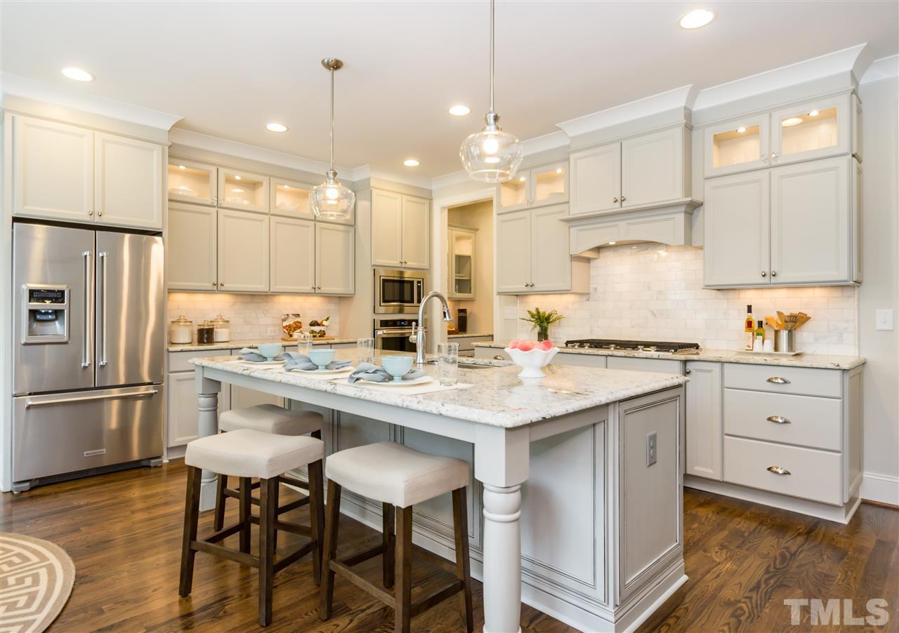 3201 Plantation Road Raleigh, NC 27609 - Photo 9 of 25 a kitchen with granite countertop a sink appliances cabinets and counter space