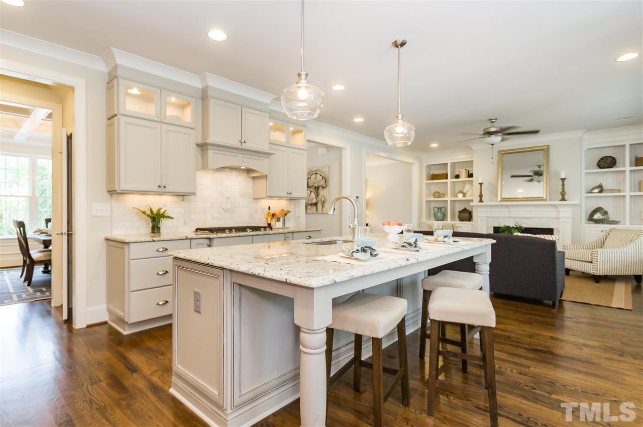 3201 Plantation Road Raleigh, NC 27609 - Photo 10 of 25 a kitchen with counter space dining table and chairs