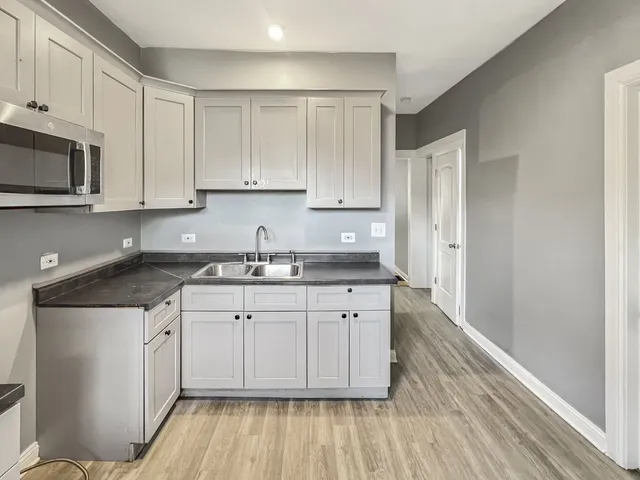 a kitchen with a refrigerator and window