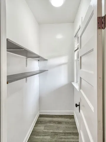 a view of a room with wooden floor