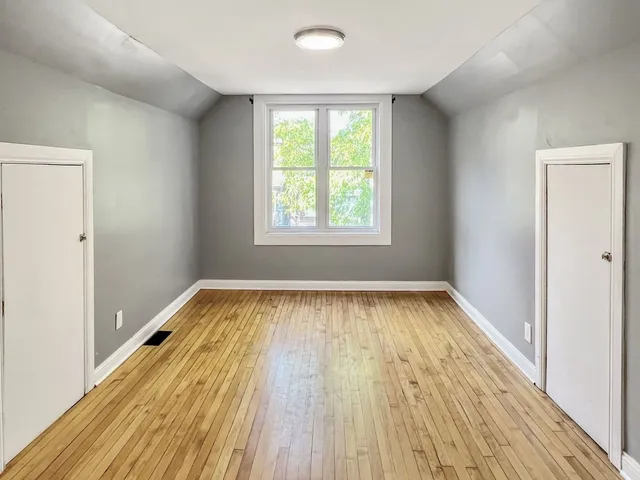 a view of a room with wooden floor and a sink