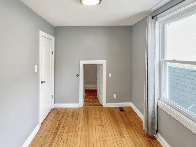 a view of a room with wooden floor and a sink