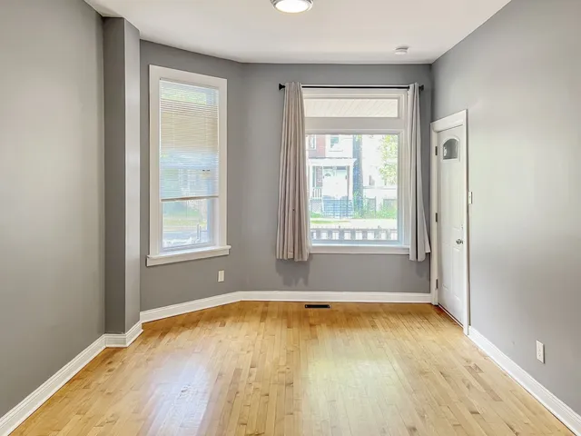 a view of a room with wooden floor and a window