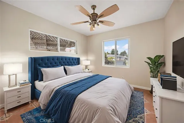 a bedroom with a bed and a window