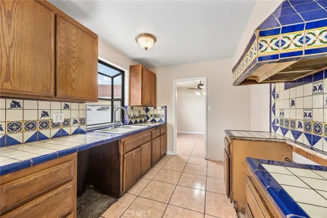 a kitchen with stainless steel appliances granite countertop a sink and cabinets