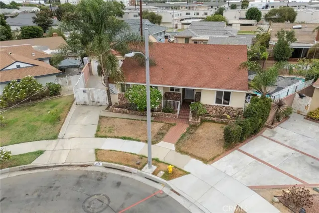 an aerial view of a house with a yard and lake view