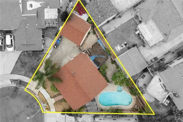 an aerial view of a house with a yard