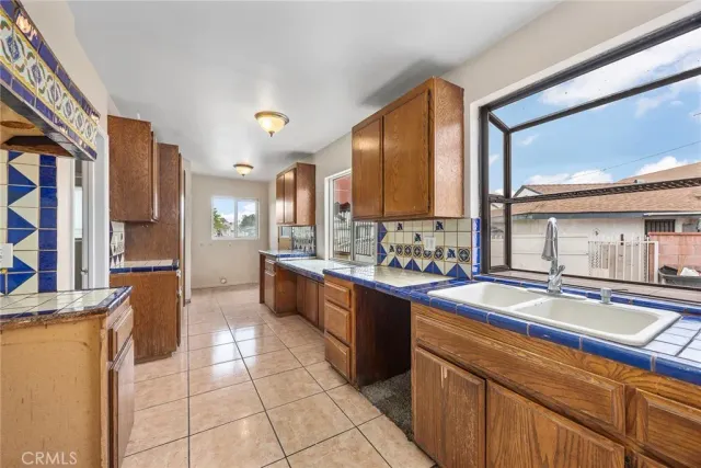 a kitchen with stainless steel appliances granite countertop a sink and cabinets