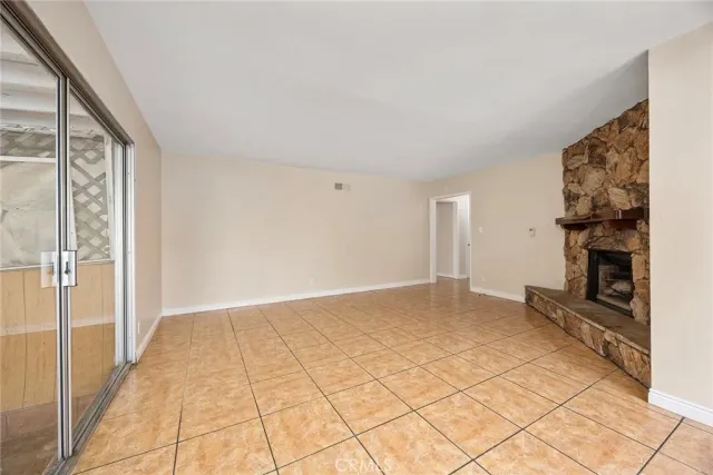 a view of an empty room and fire place