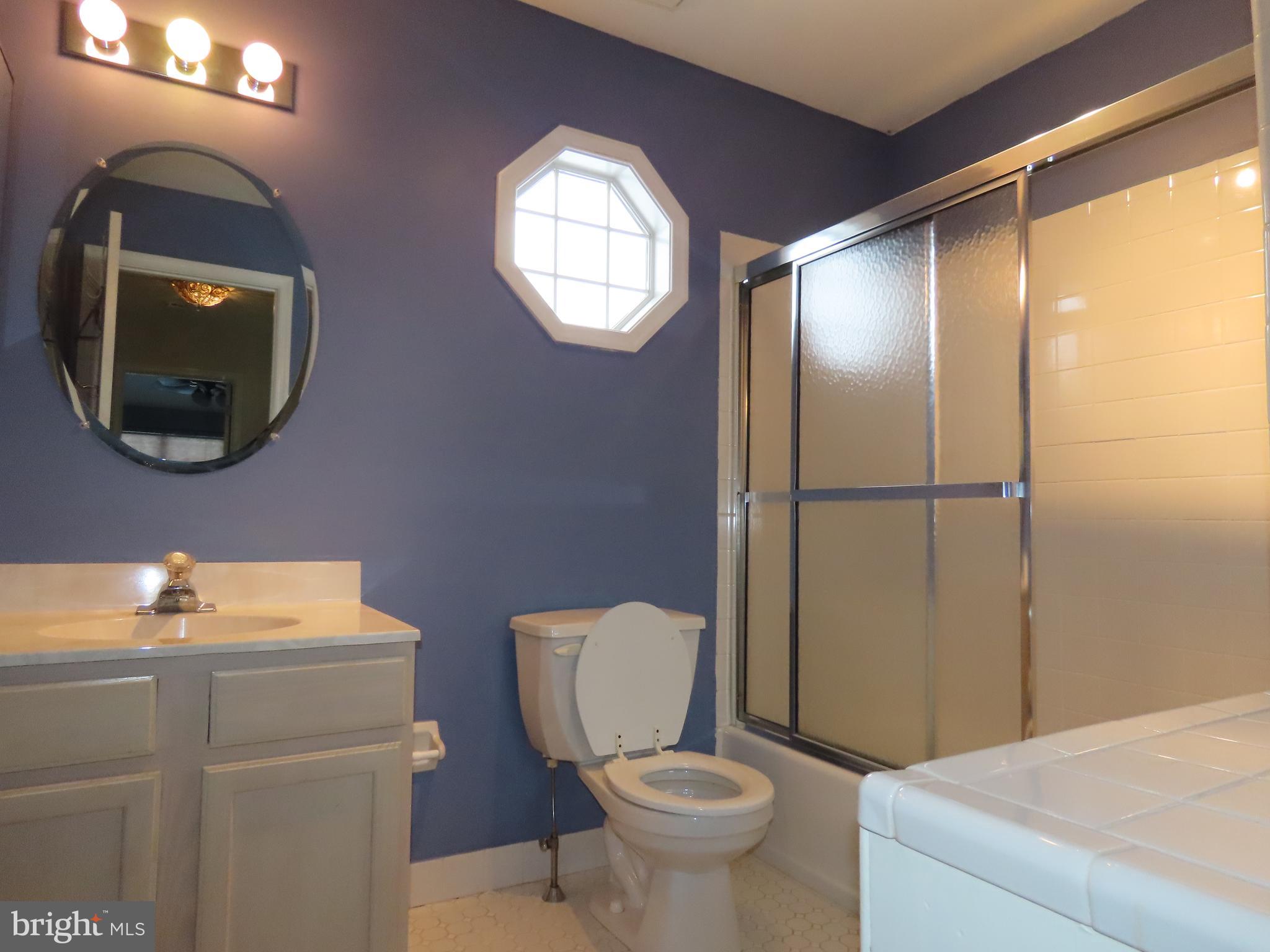 1903 Waterford Road, Unit 34 Yardley, PA 19067 - Photo 13 of 14 a bathroom with a toilet sink vanity and mirror