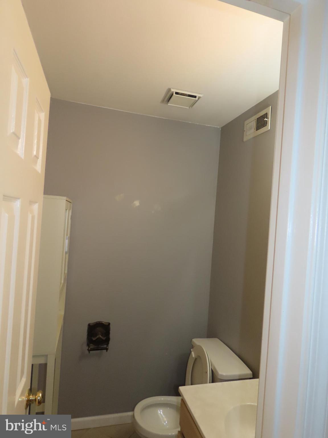 1903 Waterford Road, Unit 34 Yardley, PA 19067 - Photo 7 of 14 a white toilet sitting next to a small sink