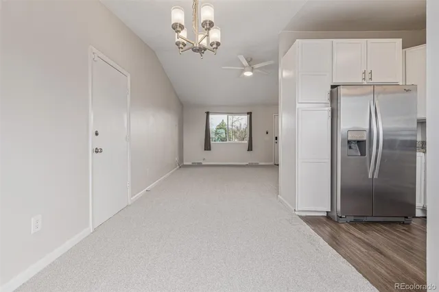 a view of a yard with wooden fence