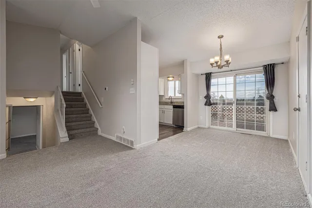 a kitchen with granite countertop a sink a stove and cabinets