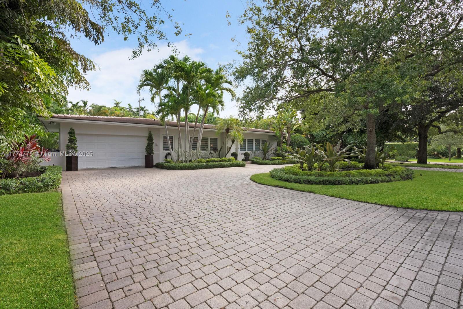 1523 Blue Road Coral Gables, FL 33146 - Photo 1 of 26 a house view with a garden space